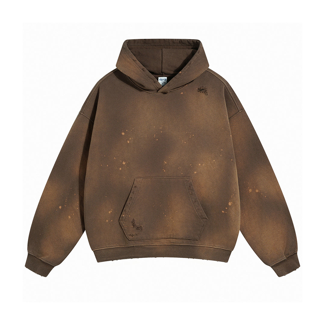 Oversized bleach-dyed cotton hoodie with distressed finish and paint splatter streetwear detail