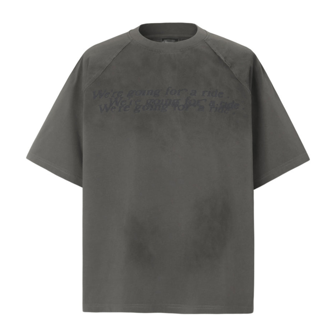 Distressed white cotton round neck tee with soft-washed garment dyed finish and rugged details