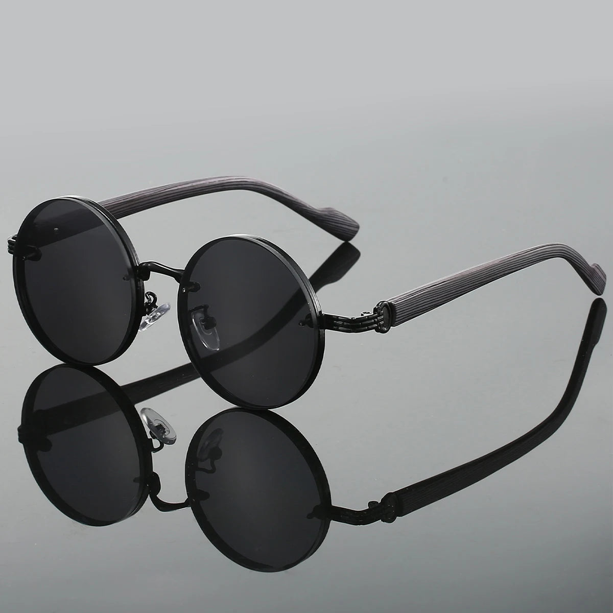 Matte black round sunglasses with textured arms and UV400 dark lenses, retro minimalist style