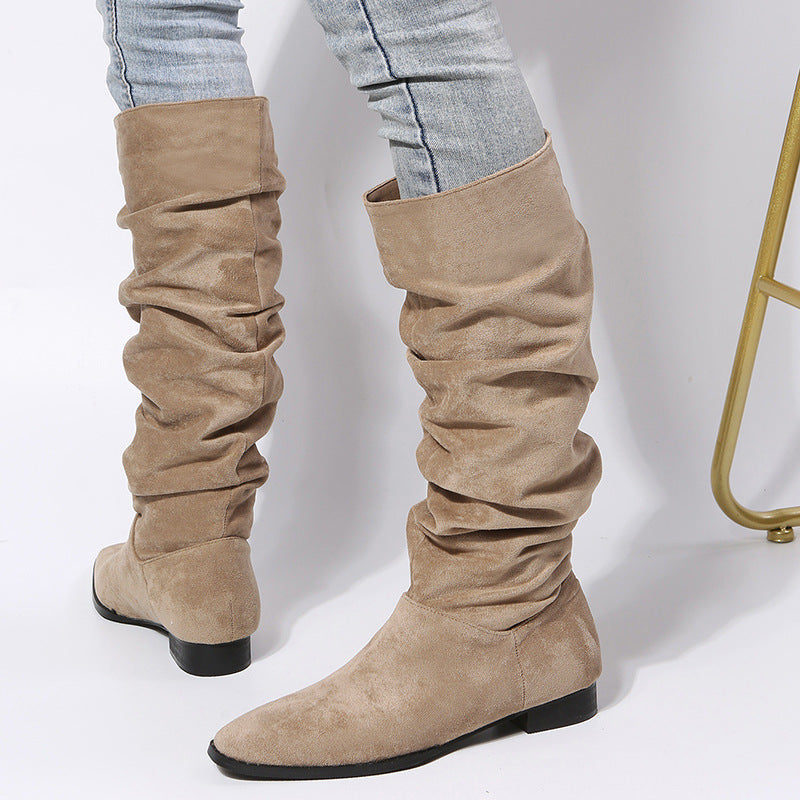 Women's slouchy knee-high boots with block heel in relaxed draped silhouette for effortless chic style