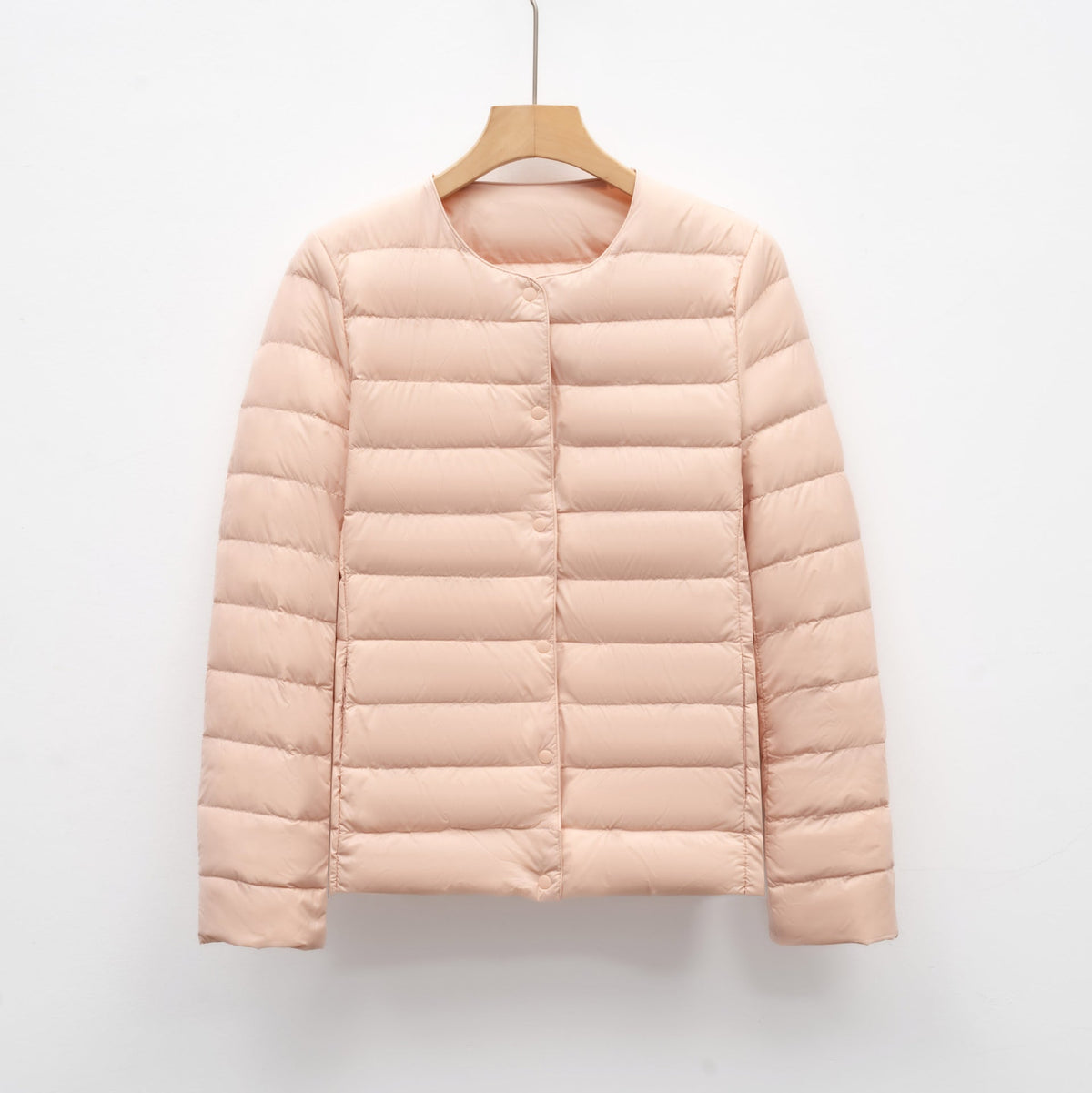 Women's slim fit lightweight quilted down jacket with snap front closure, hip length, neutral tone