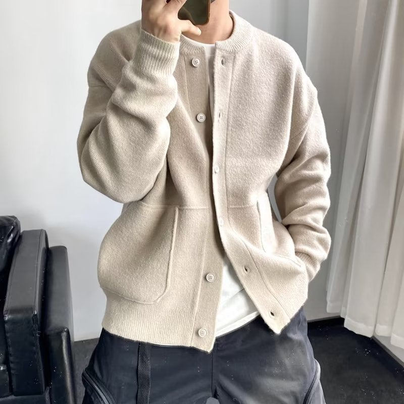 Men's gray button-up cardigan sweater with sleek modern cut and refined relaxed fit