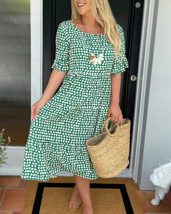 White relaxed midi dress with black dots, tiered silhouette and breathable fabric