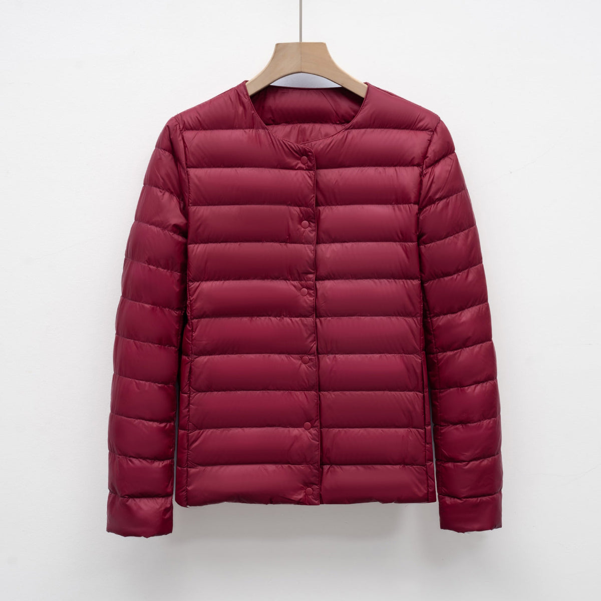 Women's slim fit lightweight quilted down jacket with snap front closure, hip length silhouette