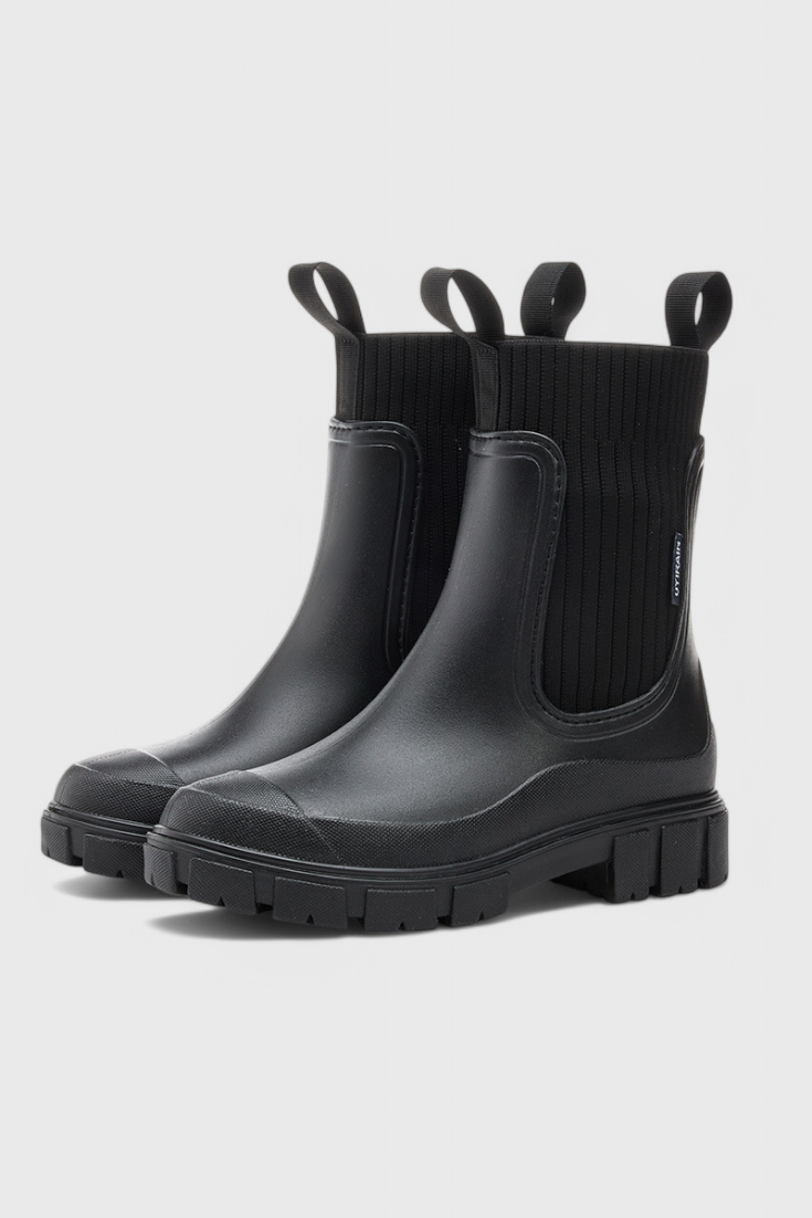 Black waterproof Chelsea boots with sleek silhouette and elastic side panels for all-weather style