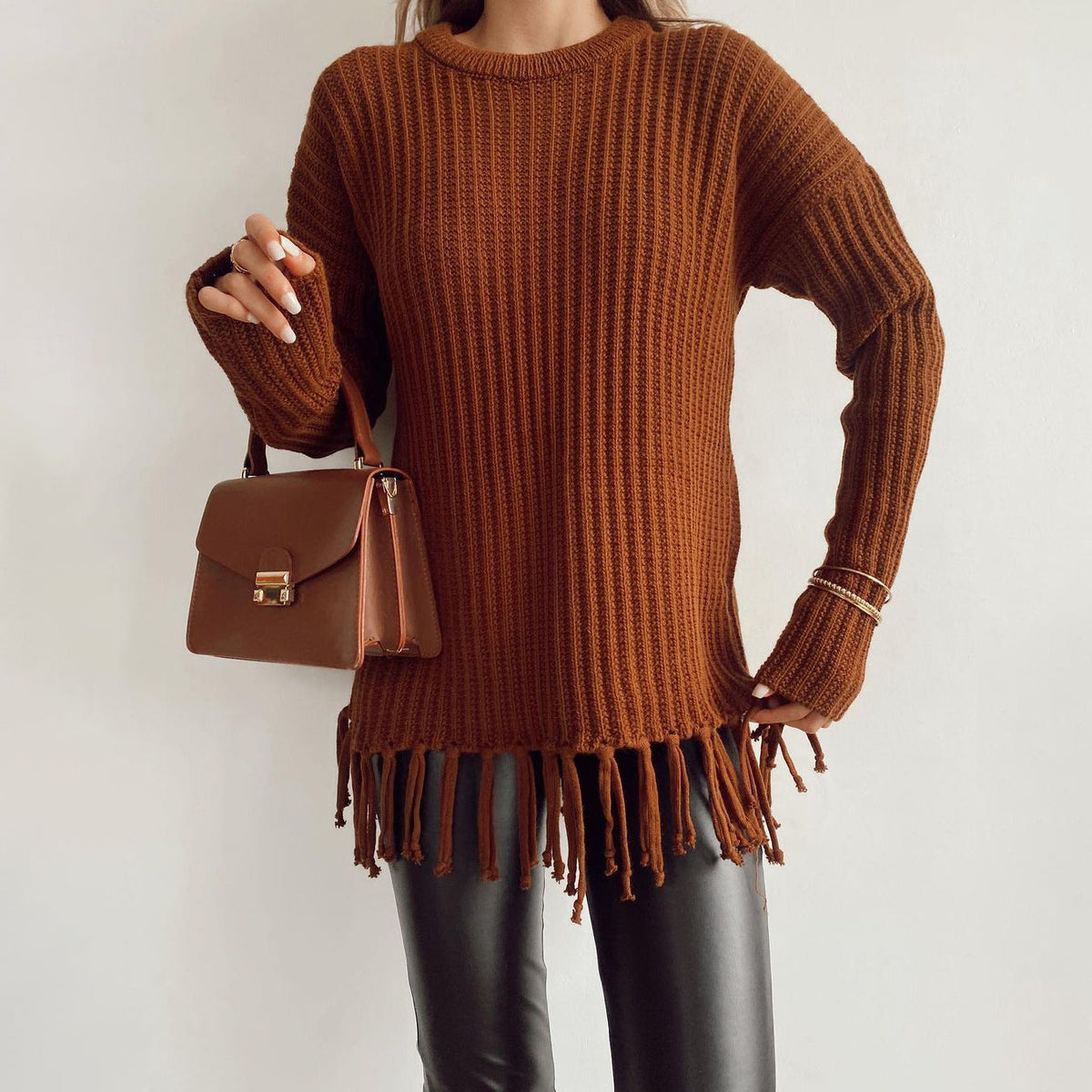 Cream oversized chunky wool pullover sweater with ribbed knit texture and fringe hem detail