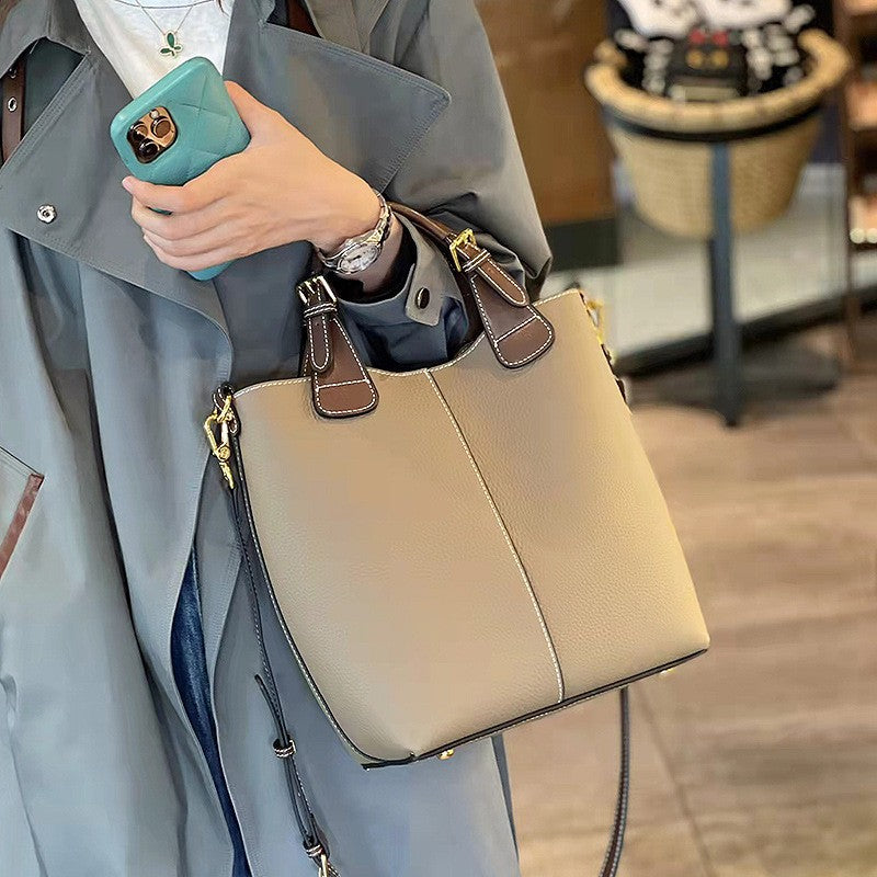 Structured beige vegan leather tote bag with contrast handles and removable crossbody strap