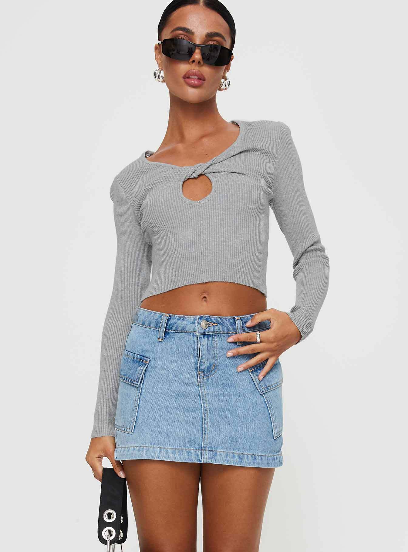 Women's slim fit blue denim mini skirt with front pockets and button zipper closure