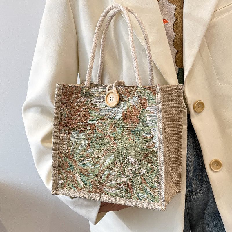 Heather floral woven tote bag in blooming colors, structured boxy shape with double-braided straps