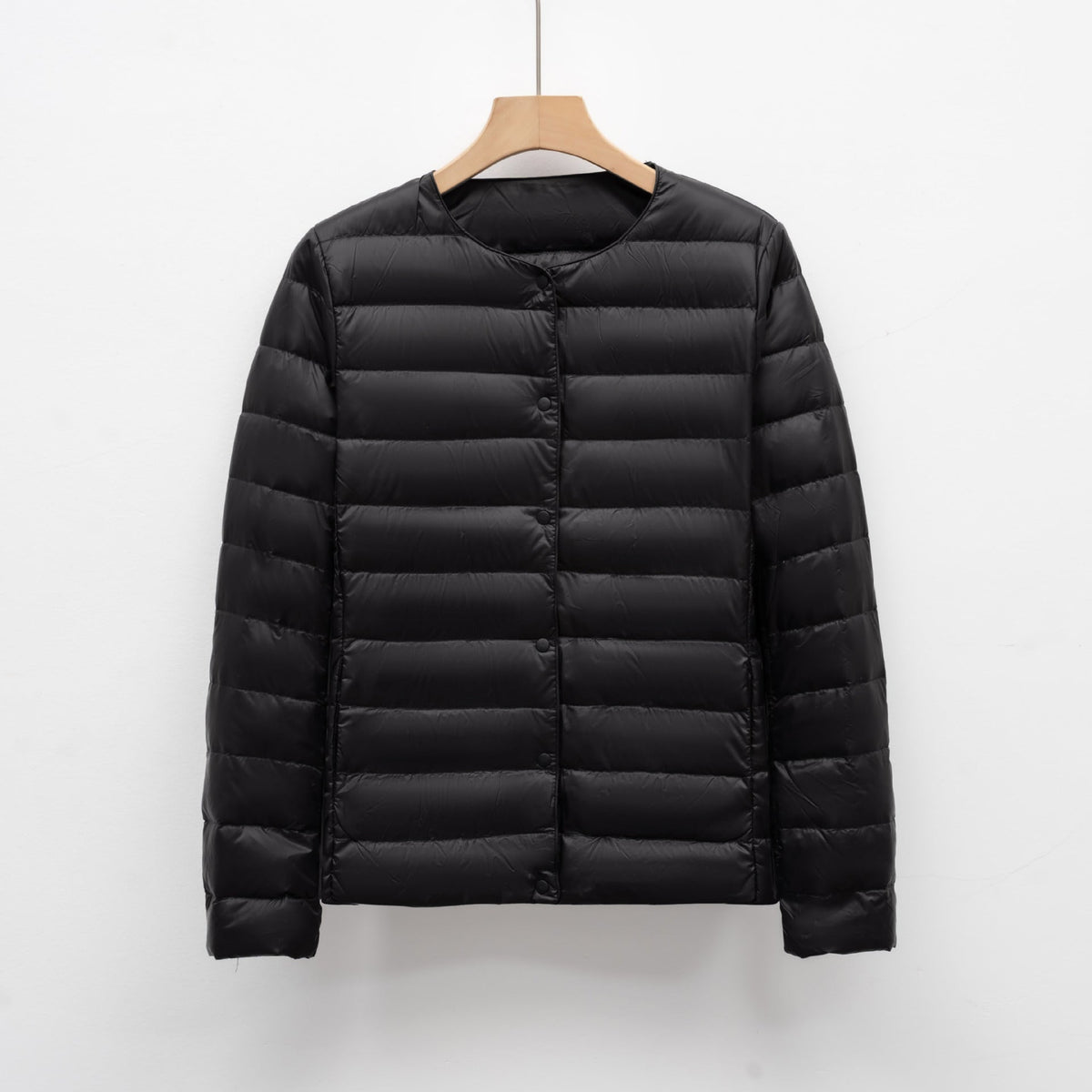 Women's slim fit lightweight quilted down jacket with snap front closure, hip length silhouette