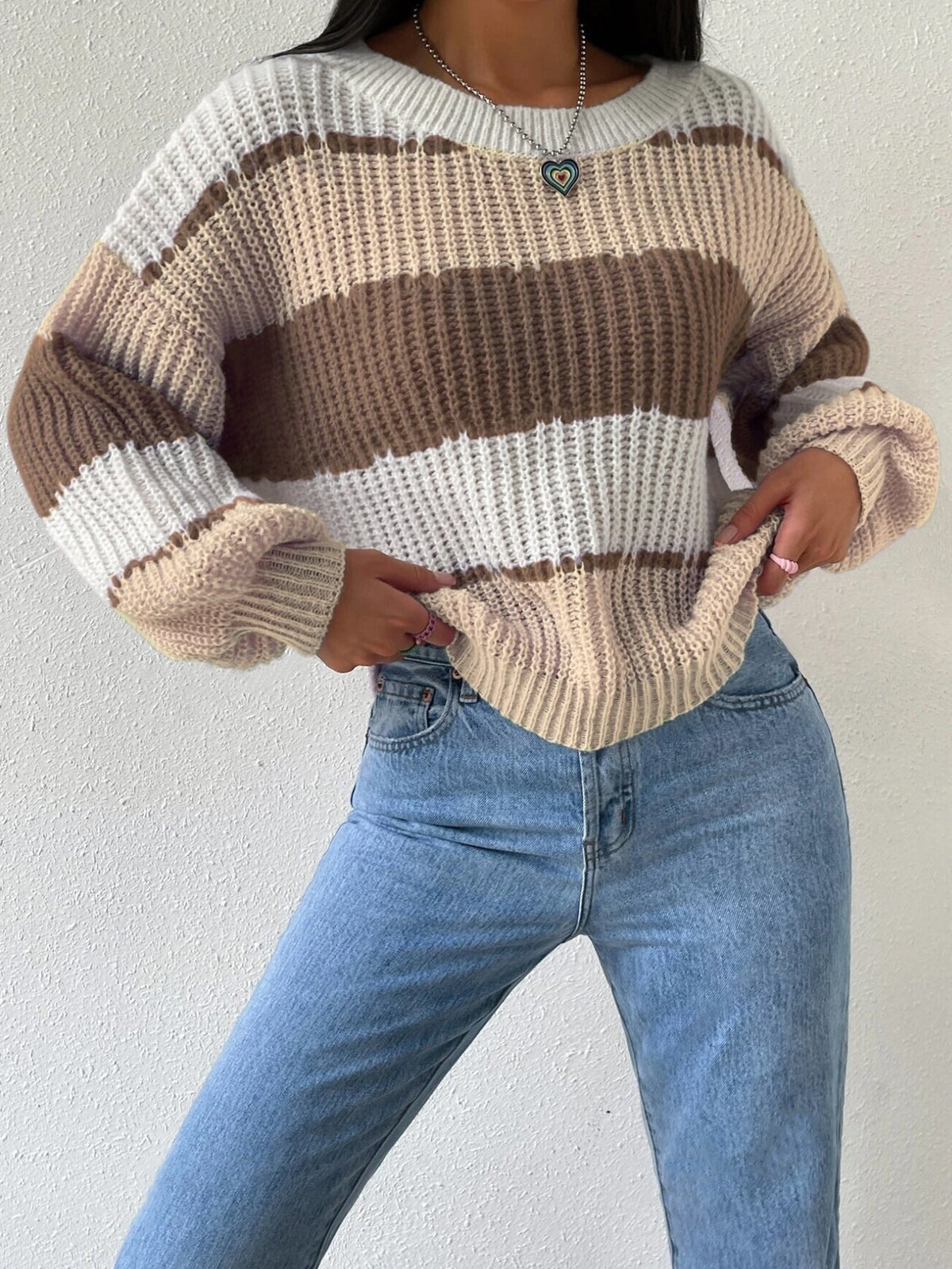 Women's striped knit pullover sweater in cozy soft fabric with classic crew neck design
