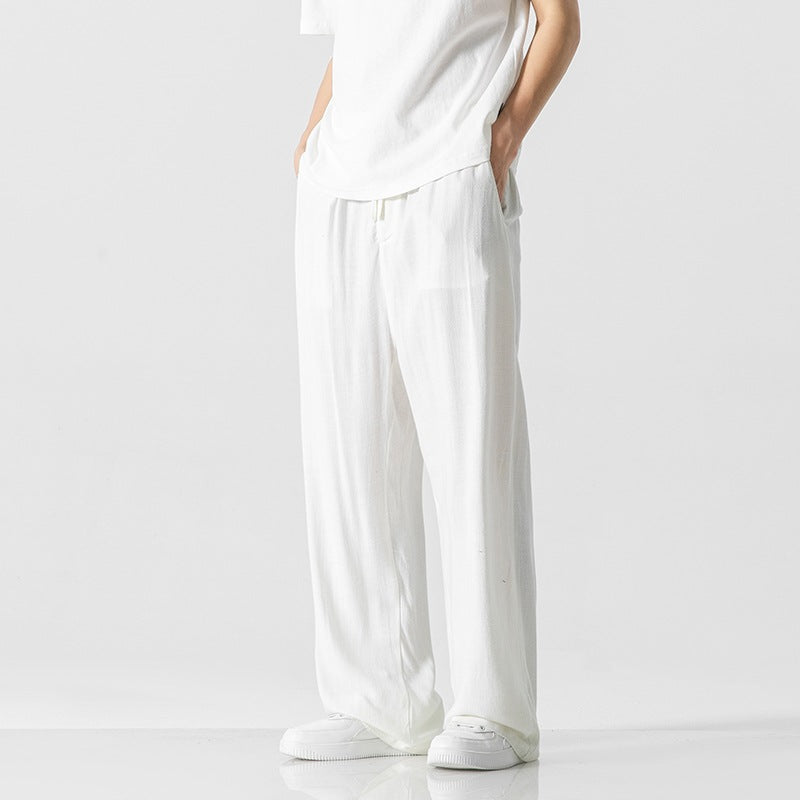 Men's loose-fit linen blend trousers in neutral tone with elastic drawstring waist for casual everyday wear