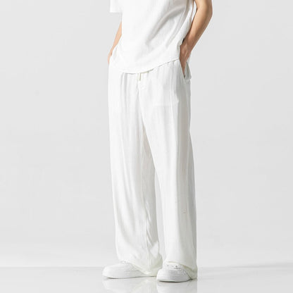 Men's loose-fit linen blend trousers in neutral tone with elastic drawstring waist for casual everyday wear
