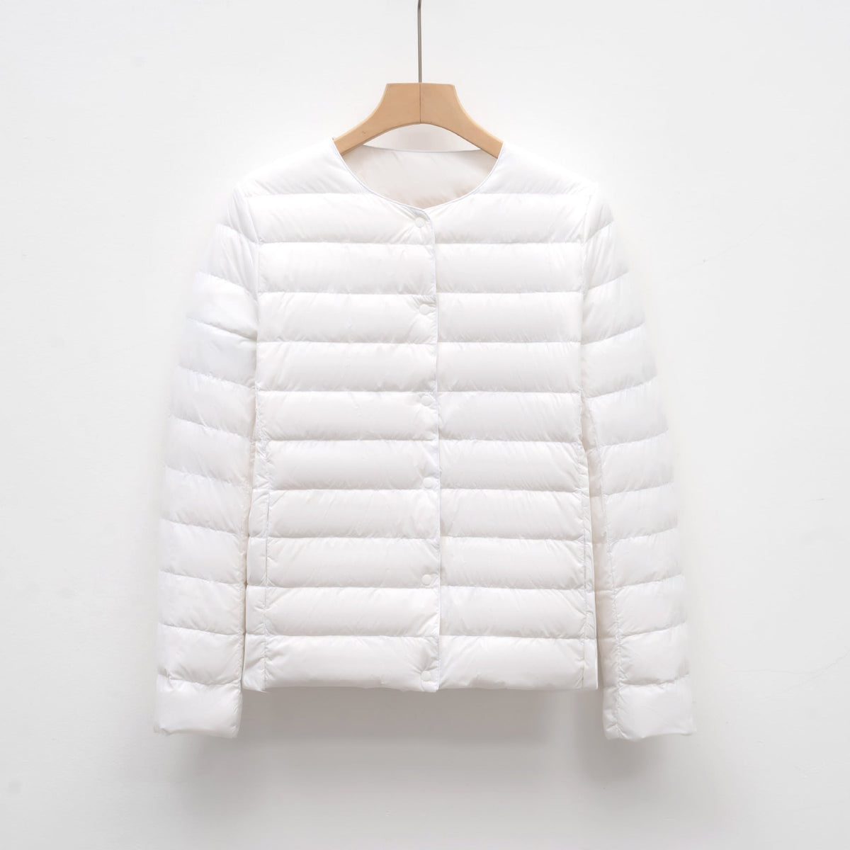 Women's slim fit lightweight quilted down jacket with snap front closure, hip length, sleek design