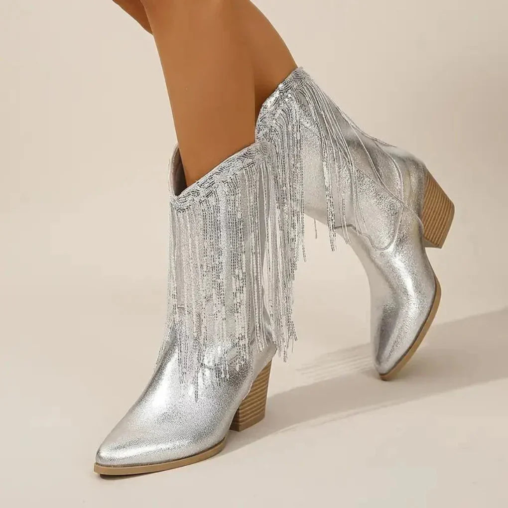 Women's silver metallic high heel boots with fringe detailing, bold glamorous style