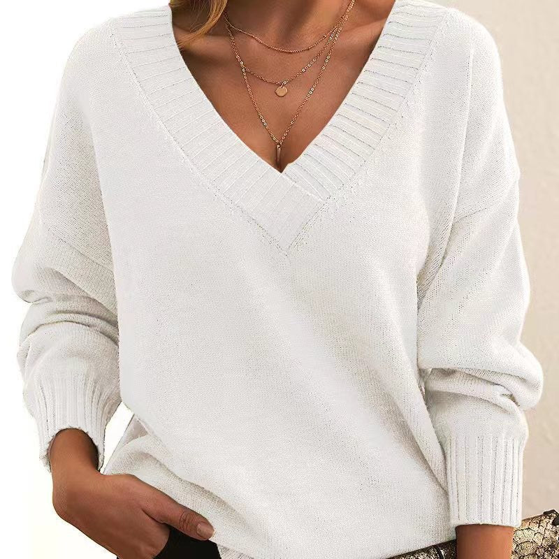 Women's beige soft knit relaxed-fit V-neck sweater with ribbed cuffs for cozy fall style