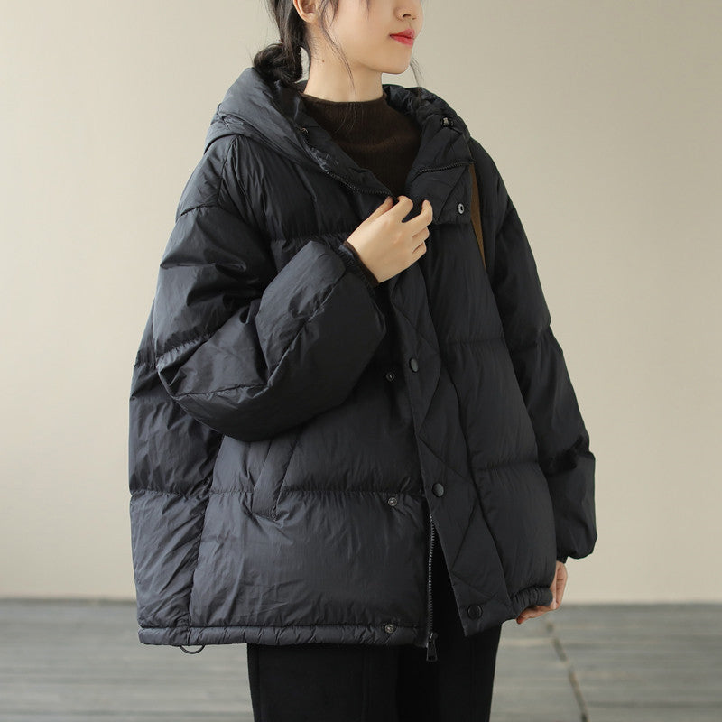Black quilted hooded puffer jacket with premium insulation, sleek winter outerwear silhouette