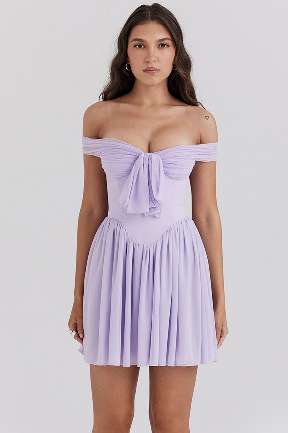 White off-shoulder mini dress with bow detail, light airy fit and fluid drape