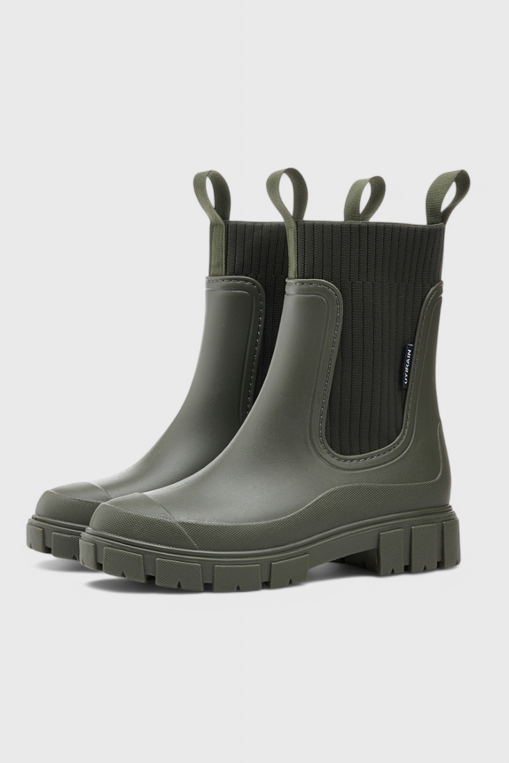 Black waterproof Chelsea boots with sleek streamlined silhouette and elastic side panels