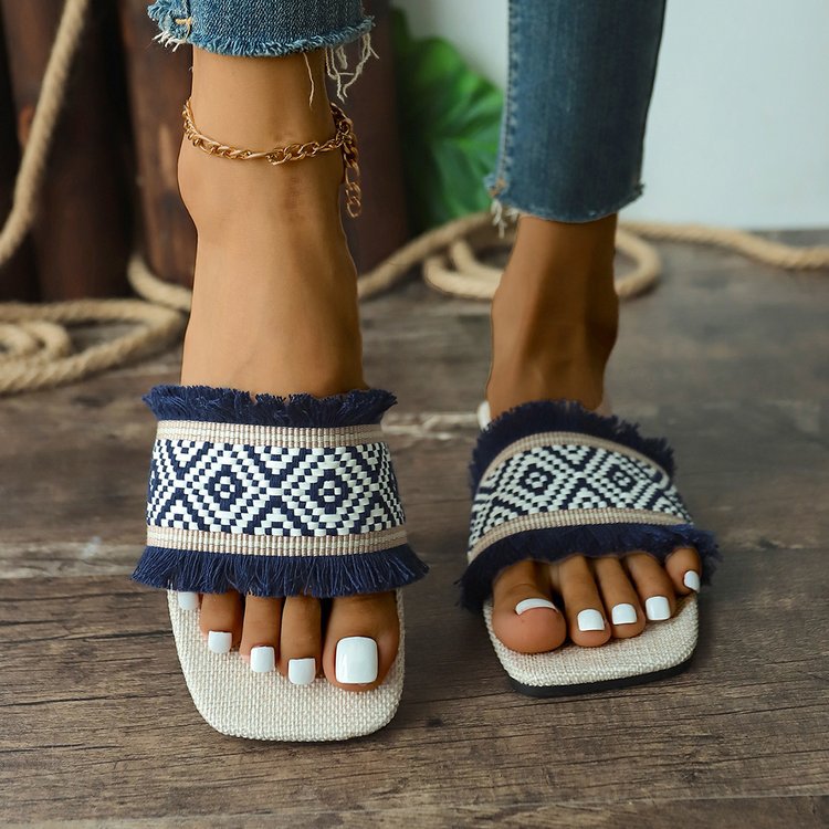 Beige bohemian flat sandals with embroidered straps and natural fringe detail for all-day wear