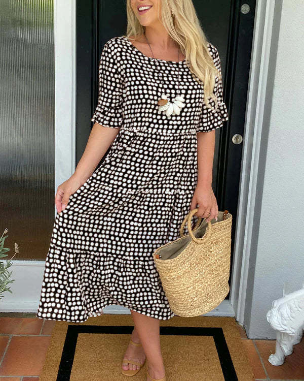 Black white dotted relaxed midi dress with softly tiered silhouette and breathable fabric
