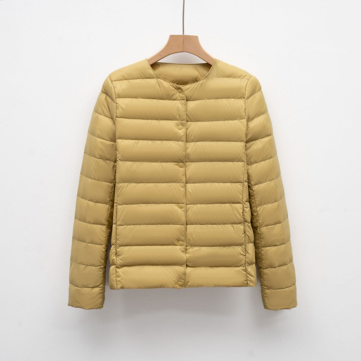 Women's slim fit lightweight quilted down jacket with snap front closure, hip length silhouette