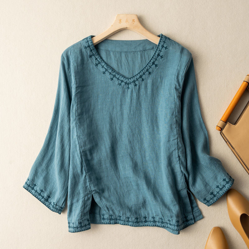 Floral embroidered V-neck blouse in soft tones with delicate stitched neckline details