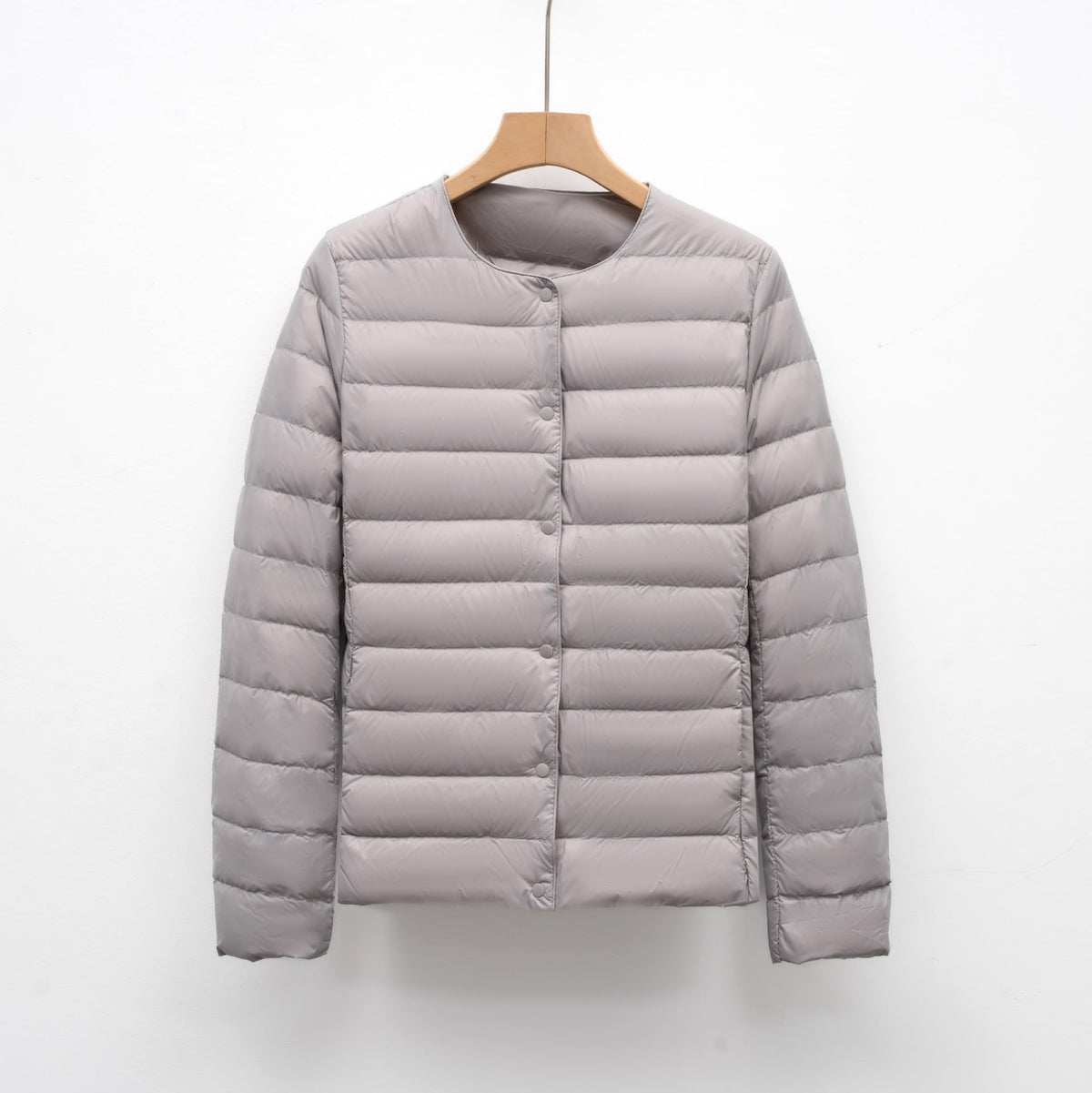 Women's slim fit lightweight quilted down jacket with snap front closure, hip length silhouette