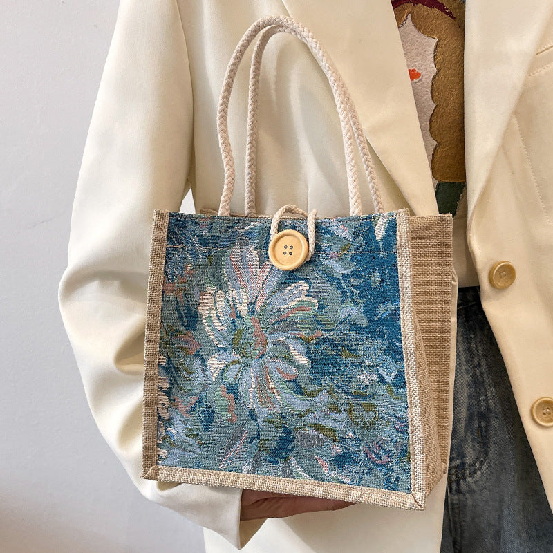 Heather floral woven tote bag in blooming colors, structured boxy shape with double-braided straps