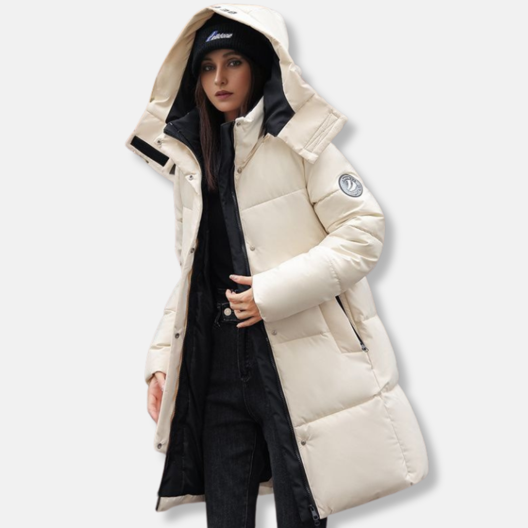 Women's mid-thigh puffer coat in neutral tone with high collar integrated hood for ultra-warm winter style