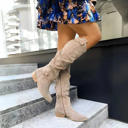 Women's brown slouchy knee-high suede boots with side zipper and low heel for effortless chic style