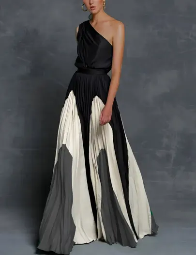 Elegant one-shoulder asymmetrical maxi dress in flowing pleated fabric with sculpted neckline