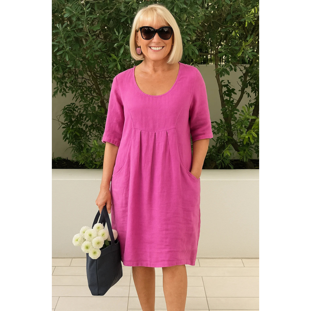 Flowy white summer dress with pleated bust detail and relaxed fit for effortless warm-weather style