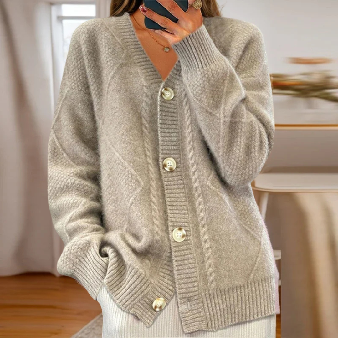 Chunky cable knit cardigan in neutral tones with classic textured pattern and relaxed cozy fit