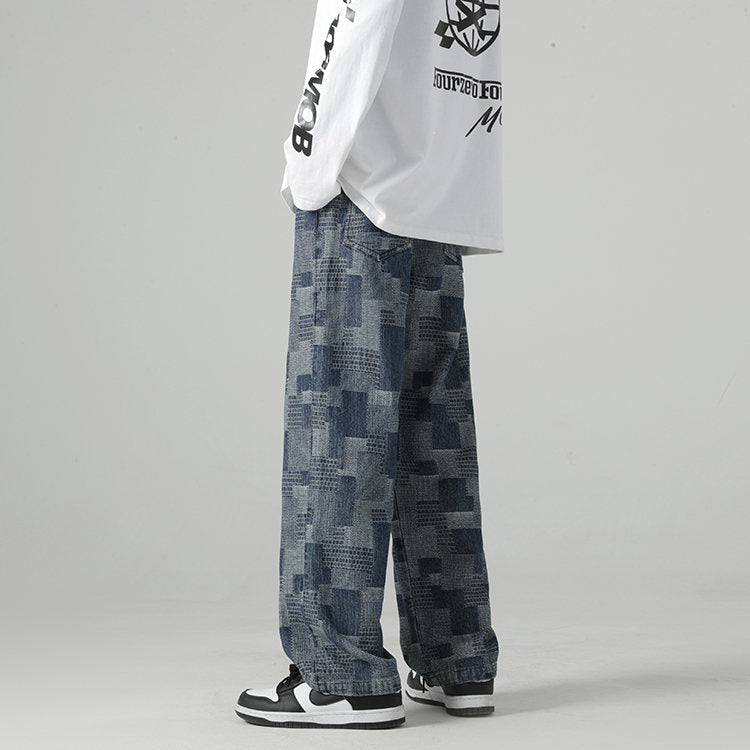 Blue denim joggers with all-over geometric jacquard texture, relaxed straight-leg fit, Paul Klee-inspired modernist print