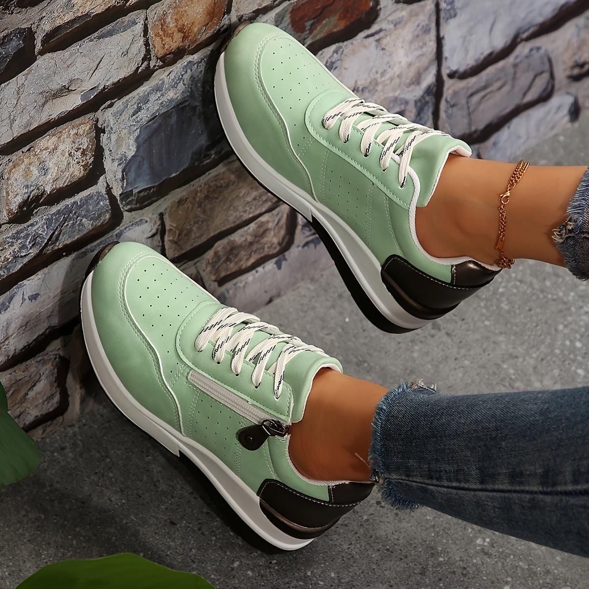 Women's white perforated low-top sneakers with lace-up closure and breathable upper