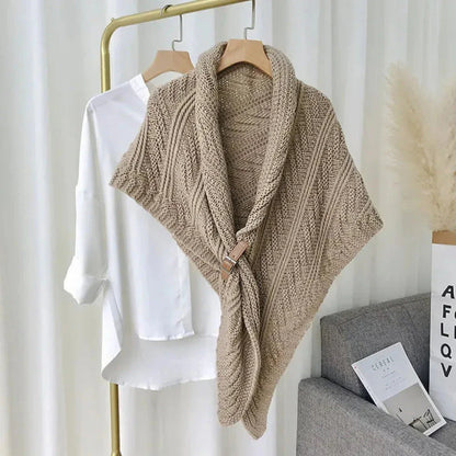 Chunky cable-knit shawl wrap with adjustable buckle closure, cozy winter layering piece
