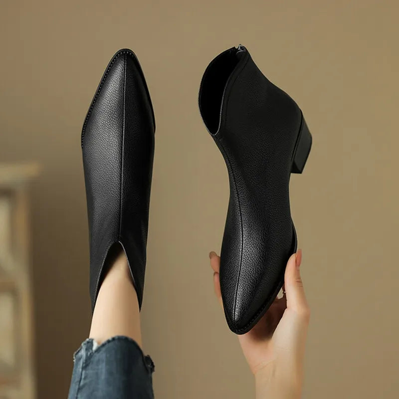 Women's black pointed-toe ankle boots with chic block heel, sleek silhouette for work and evening wear