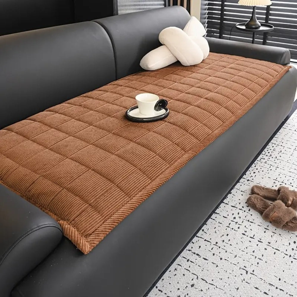 Quilted sofa cover with non-slip backing, cozy texture, spill and pet hair protection