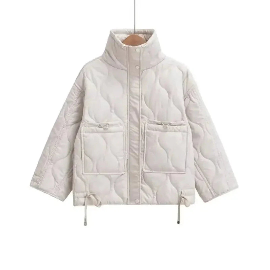 Black quilted puffer jacket with stand collar and wave-pattern stitching for cold-weather style