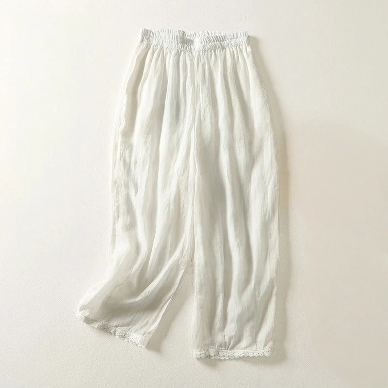 Rhea cropped linen trousers with relaxed fit, stretch waistband, and soft gathered drape