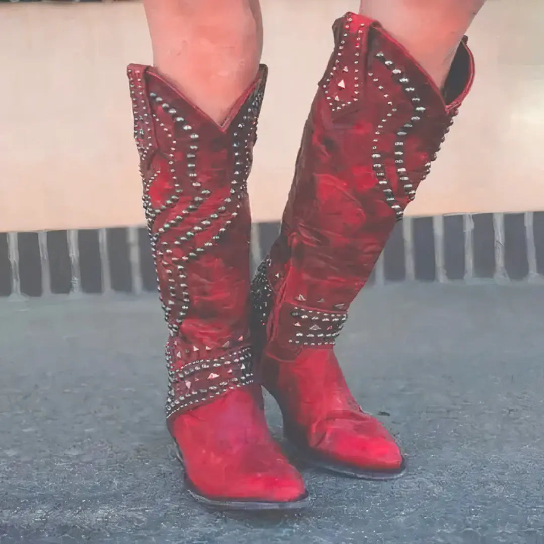 Women's black long heel boots with edgy rivet embellishments and sleek chic silhouette