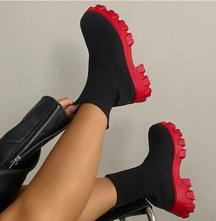 Women's black chunky heel slip-on boots with stretch-fit upper and rugged lug sole for bold street style