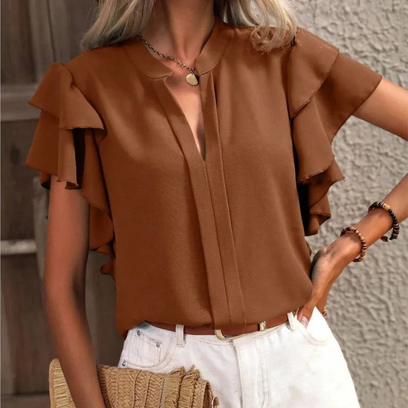 Chic women's blouse with elegant ruffle sleeves, flowing fabric, feminine silhouette in soft pastel tone