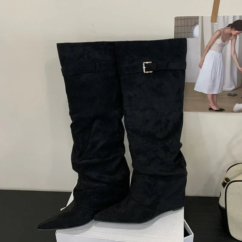 Women's brown leather thigh-high boots with bold buckle detail, sleek silhouette