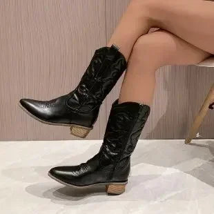 Women's leather knee-high boots with Western-inspired stitching details and structured heel silhouette