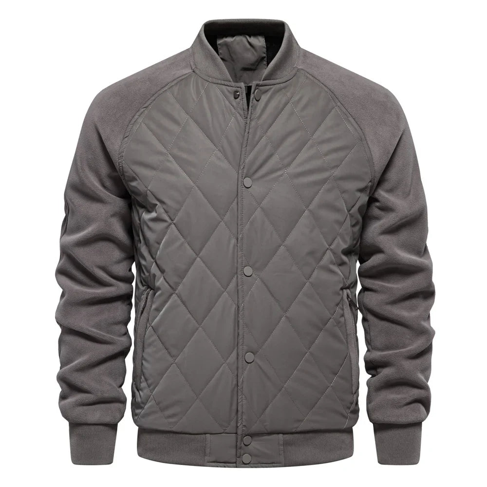 Navy quilted bomber jacket with suede-texture sleeves, diamond-quilted front, and ribbed trim