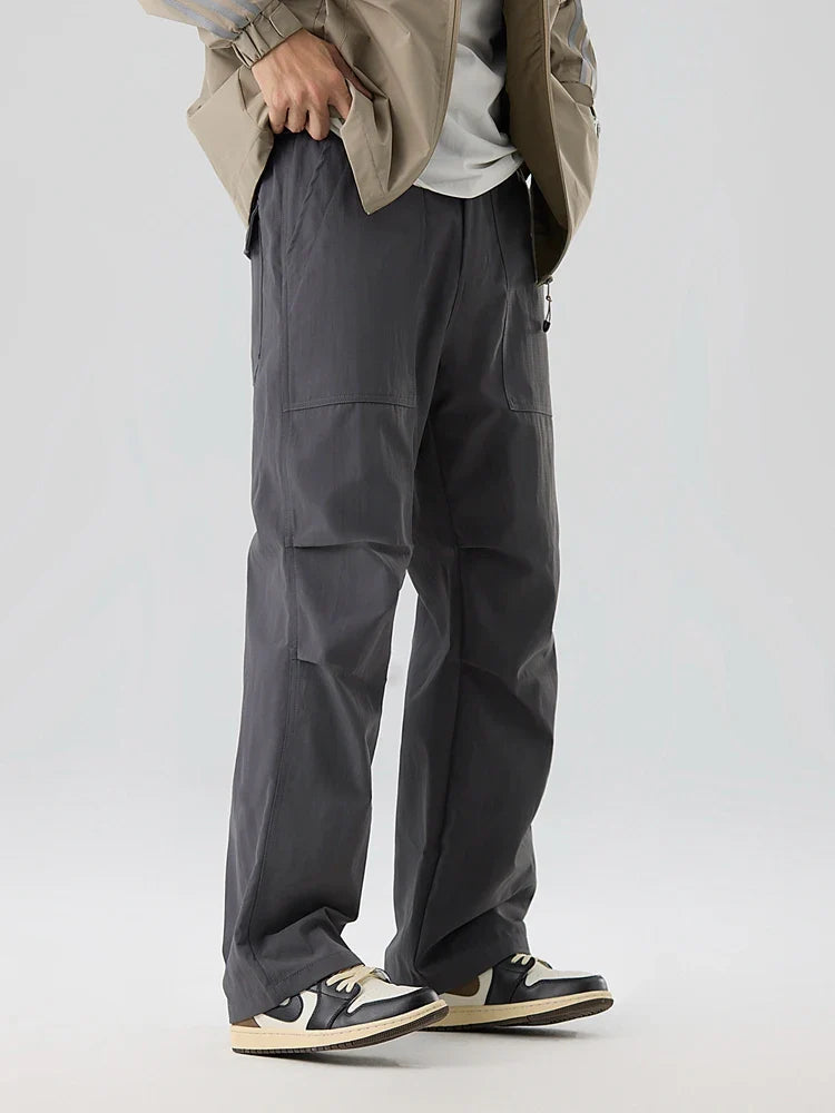 Water-resistant nylon cargo pants with grid weave texture, elastic waistband, and deep utility pockets
