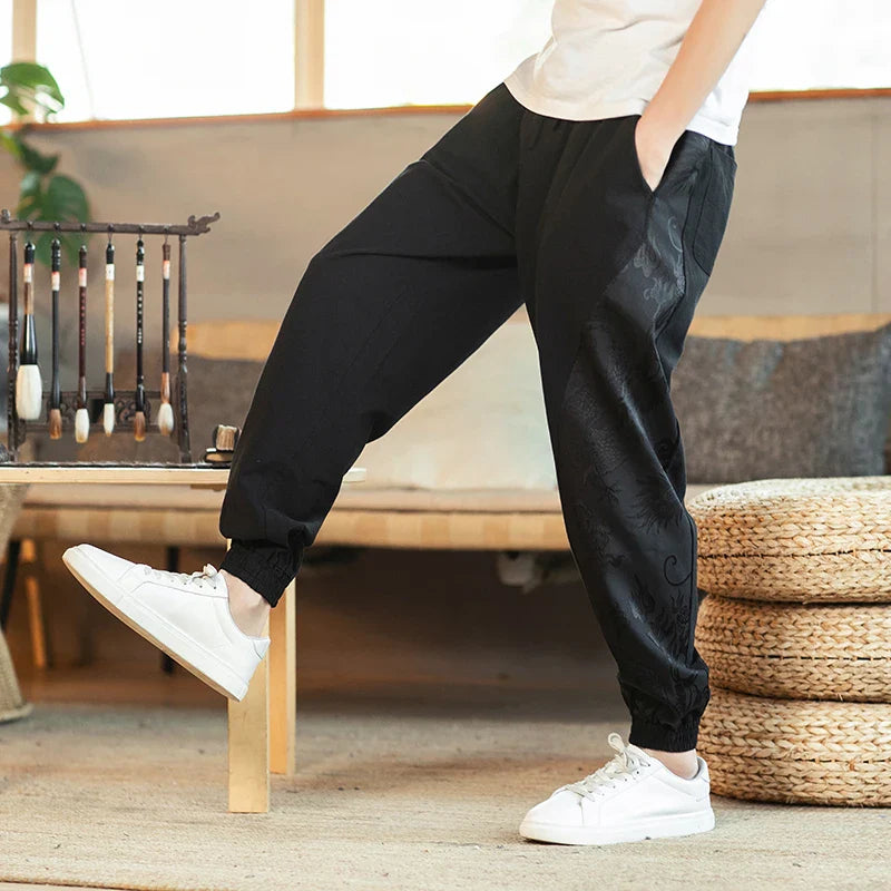 Black cotton-linen harem pants with tapered hem and Japanese dragon side artwork