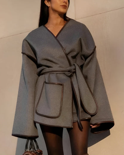 Women's oversized striped overcoat with leather trim, drop shoulders, and flared sleeves in lightweight fabric
